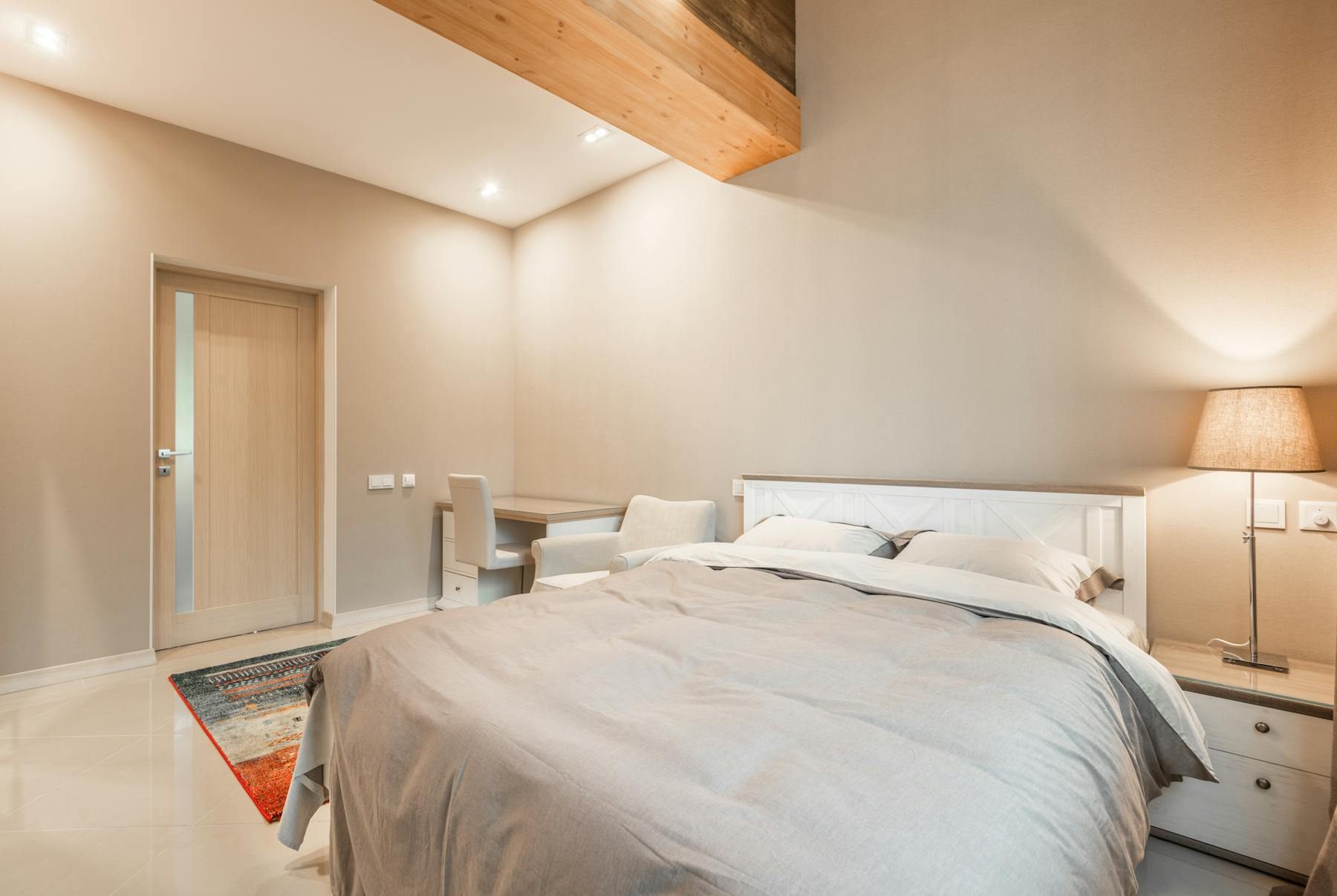 Bedroom with the bed on a solid wall and a clear path around it