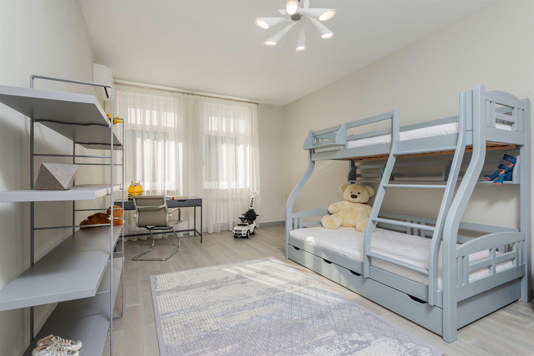 Kids bedroom with bunk bed, neutral walls, and built-in storage