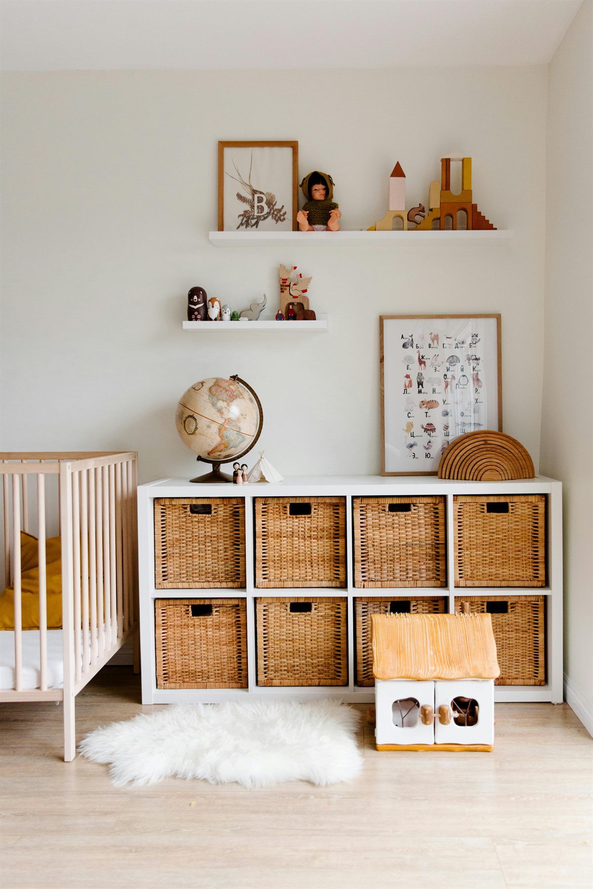 Children's storage shelves with toys and books organized into baskets and cubbies