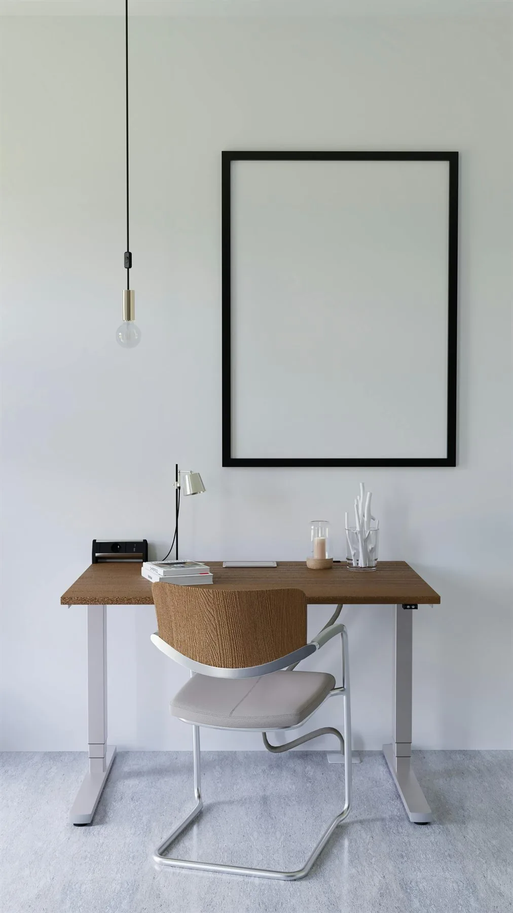 Wood desk and white chair in a simple office with a large blank frame and a pale wall