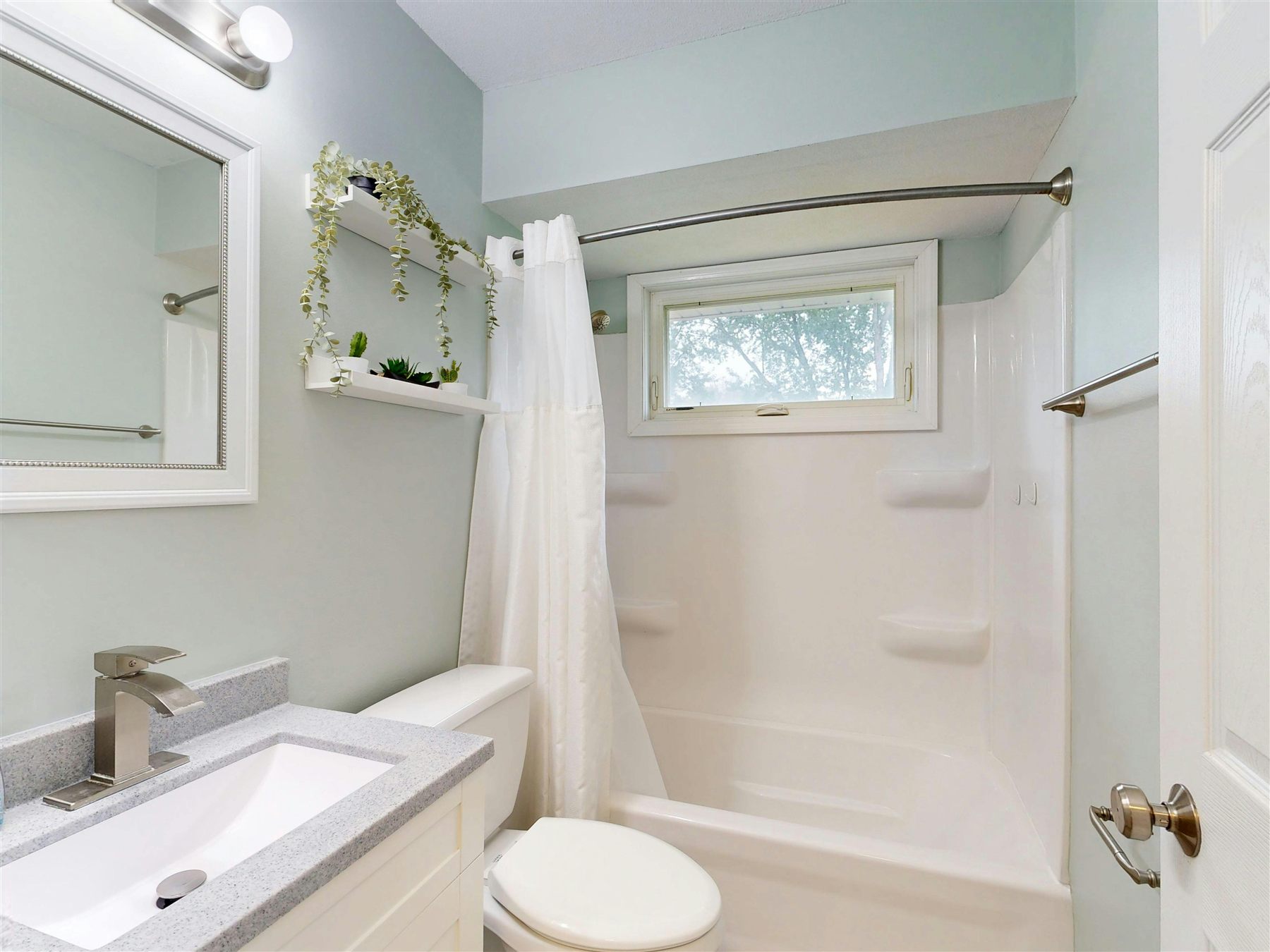 Bathroom vanity with fewer visible items, clean countertop, and brighter styling
