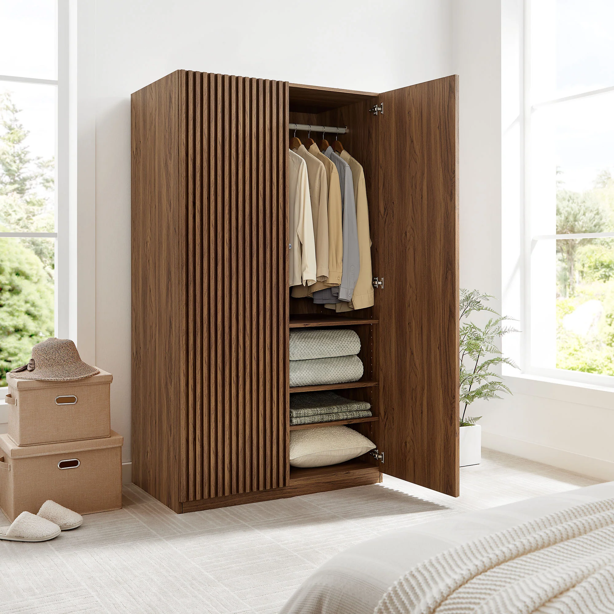 Walnut slatted wardrobe with one door open showing folded bedding and hung clothes