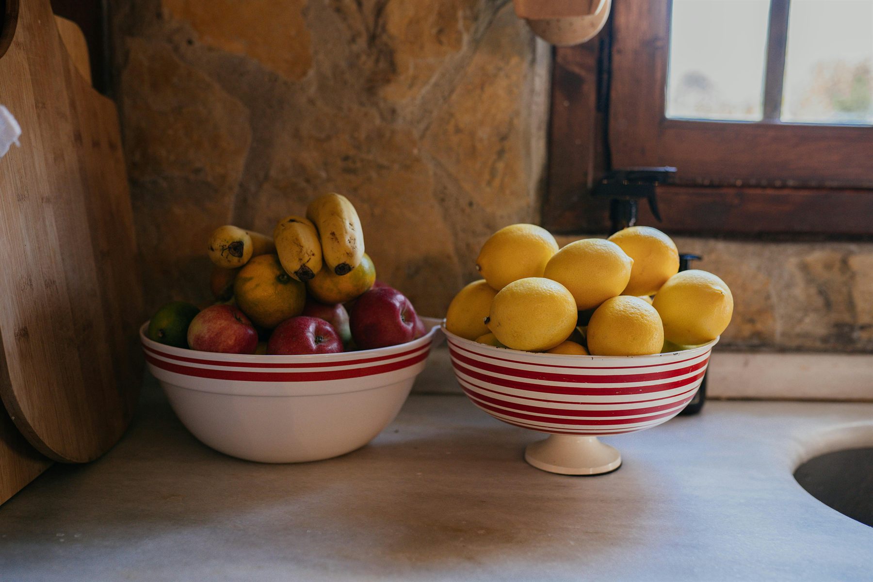 Fresh fruit bowls on a warm-toned dining or kitchen-adjacent surface