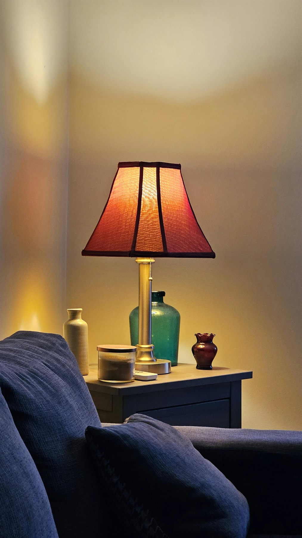 Warm lamp lighting a small corner table